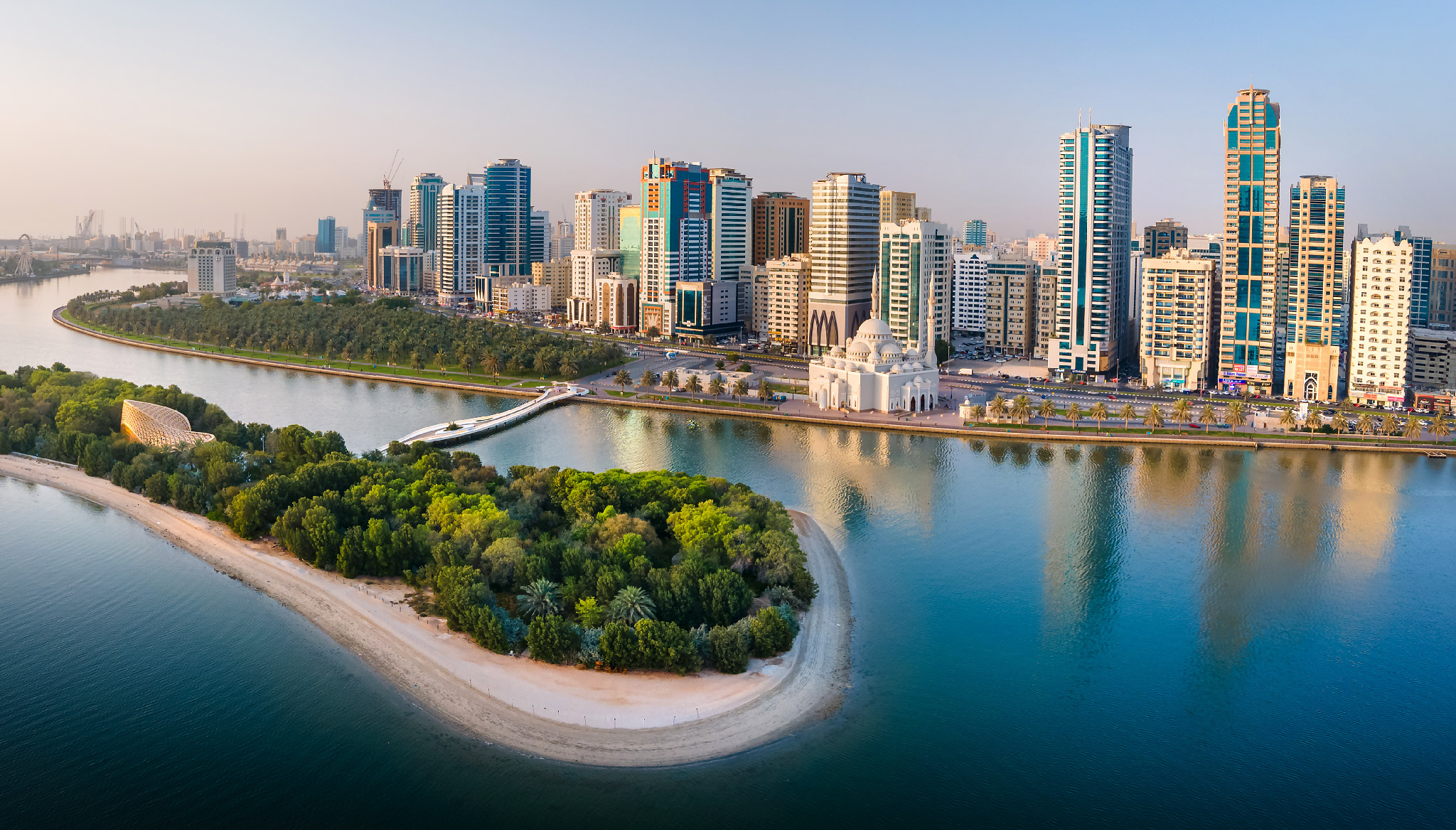 Scenic view of Al Noor Island in Sharjah featuring lush greenery and calm waters.